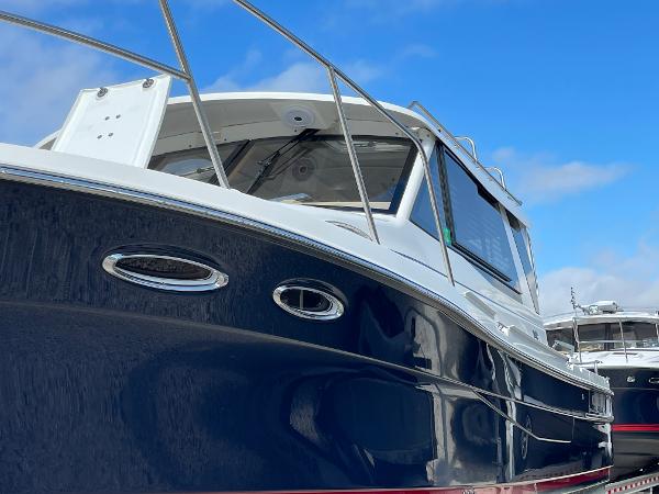 Slide: The Image of 2016 Cutwater 30 Sedan LE boat with sleek blue hull and modern design. - 2
