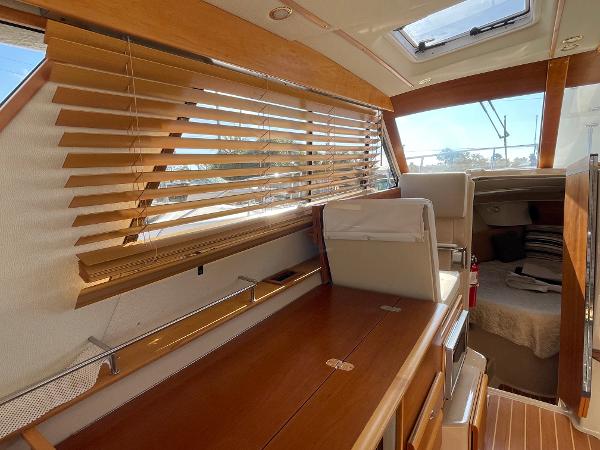Slide: The Image of Interior of 2016 Cutwater 30 Sedan LE with wooden blinds and seating area. - 23