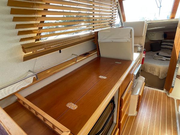 Slide: The Image of Interior of 2016 Cutwater 30 Sedan LE with wooden cabinetry and blinds. - 24