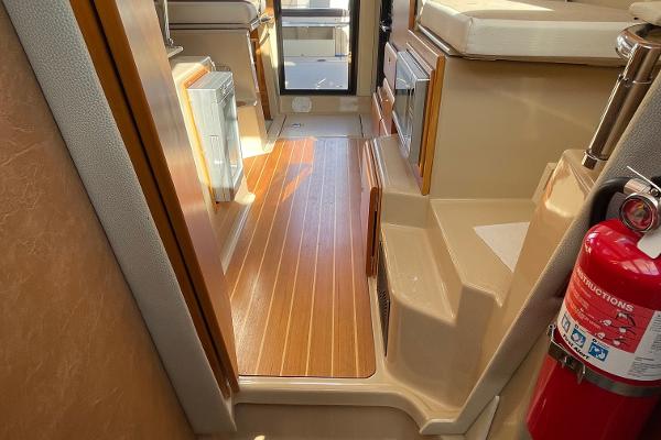 Slide: The Image of Interior of 2016 Cutwater 30 Sedan LE with wood flooring and fire extinguisher. - 27