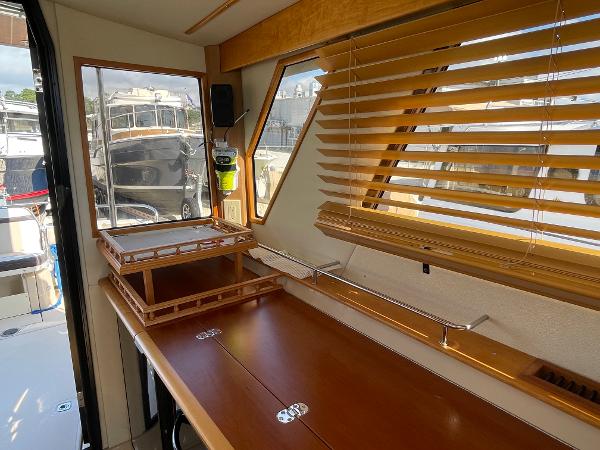 Slide: The Image of Interior of 2016 Cutwater 30 Sedan LE with wooden blinds and table. - 28