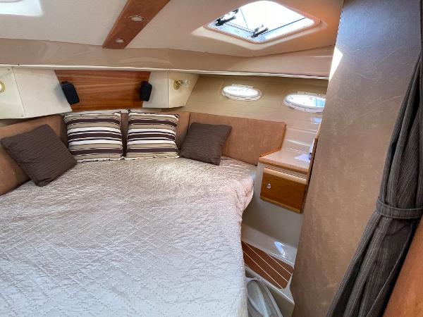 Slide: The Image of Cozy cabin interior of 2016 Cutwater 30 Sedan LE with bed and portholes. - 34