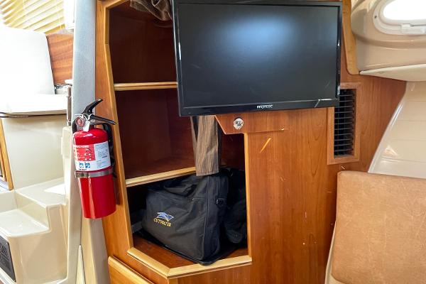 Slide: The Image of Interior of 2016 Cutwater 30 Sedan LE with TV, shelves, and fire extinguisher. - 35