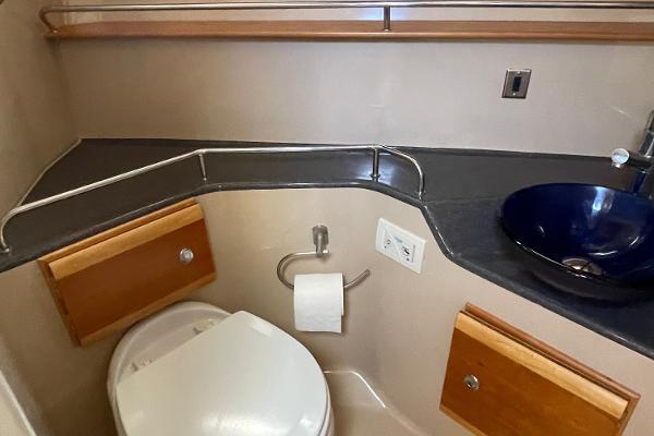 Slide: The Image of 2016 Cutwater 30 Sedan LE bathroom with modern sink and wooden cabinetry. - 36