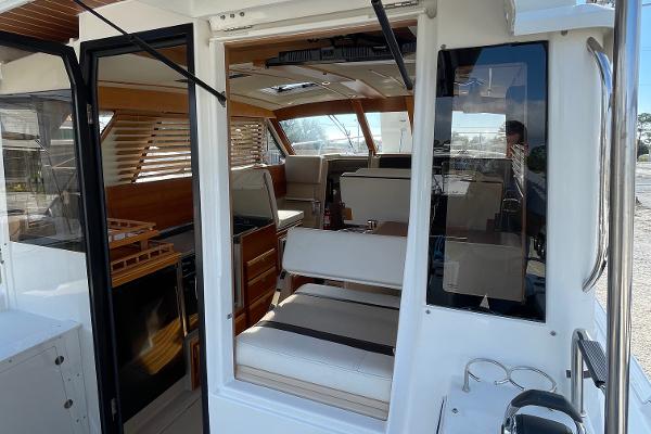 Slide: The Image of Interior view of 2016 Cutwater 30 Sedan LE boat, featuring seating and wooden accents. - 5