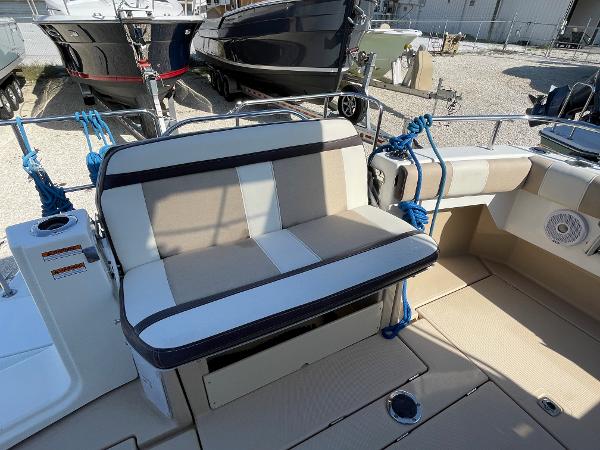 Slide: The Image of 2016 Cutwater 30 Sedan LE boat with beige and white seating in a marina. - 6