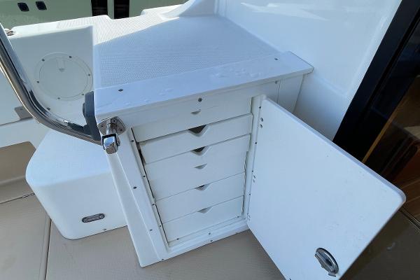 Slide: The Image of Open storage cabinet on 2016 Cutwater 30 Sedan LE boat deck. - 9