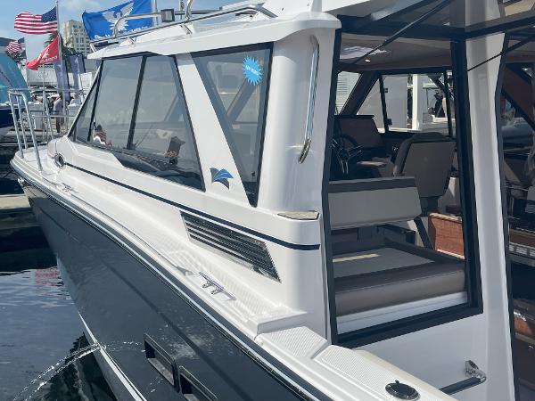 Slide: The Image of 2023 Cutwater C-288 boat docked, side view showing cabin and seating area. - 4
