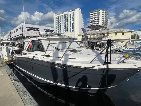 Slide: The Image of 2023 Cutwater C-288 boat docked at a marina with buildings in the background. - 7