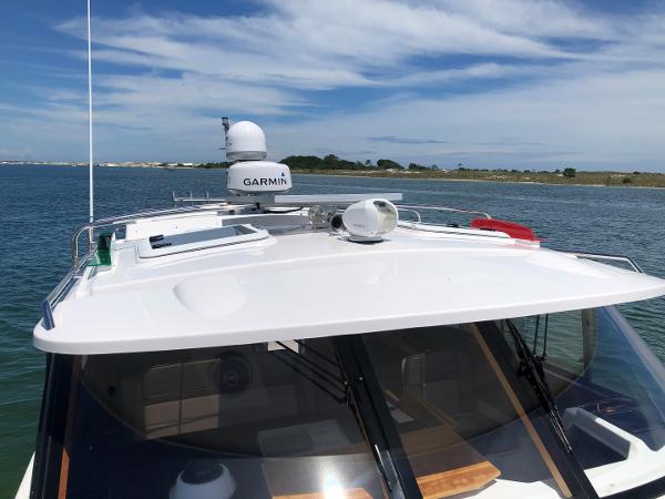 Slide: The Image of 2025 Cutwater C-32 Sedan boat with Garmin equipment on a sunny day. - 11