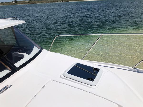 Slide: The Image of 2025 Cutwater C-32 Sedan yacht on clear water, showcasing sleek design and luxury features. - 12