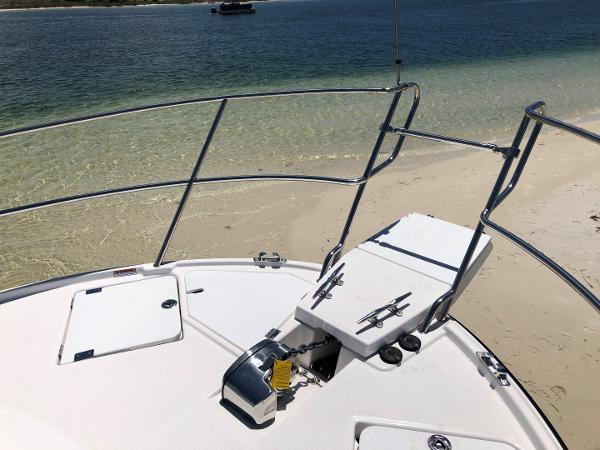 Slide: The Image of 2025 Cutwater C-32 Sedan boat anchored on sandy beach with clear water. - 13