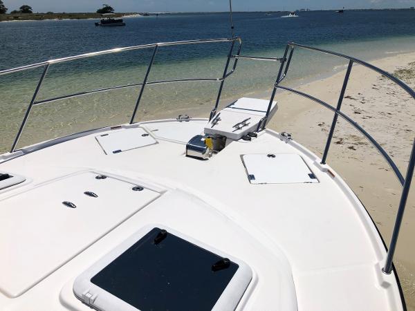 Slide: The Image of 2025 Cutwater C-32 Sedan yacht anchored on sandy beach with ocean view. - 14
