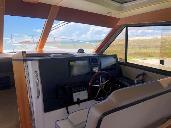 Slide: The Image of Interior of 2025 Cutwater C-32 Sedan boat with modern navigation controls. - 17