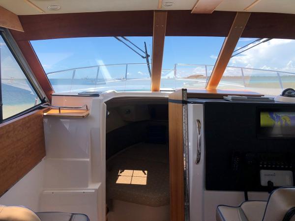 Slide: The Image of Interior view of 2025 Cutwater C-32 Sedan, featuring cabin and helm area. - 18