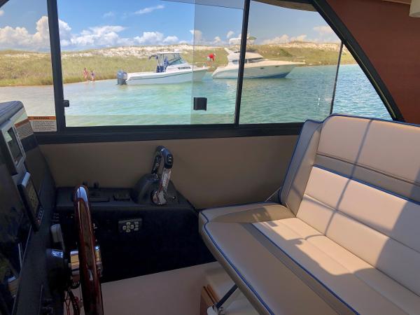 Slide: The Image of Interior view of 2025 Cutwater C-32 Sedan with scenic water and boats outside. - 20
