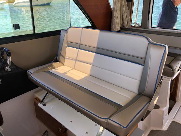 Slide: The Image of 2025 Cutwater C-32 Sedan interior with stylish seating and window view. - 21