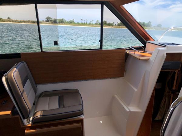 Slide: The Image of Interior of 2025 Cutwater C-32 Sedan boat with seating and scenic water view. - 22