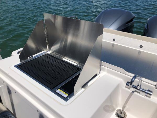 Slide: The Image of Outdoor grill on 2025 Cutwater C-32 Sedan boat, near water. - 7