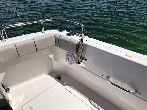 Slide: The Image of 2025 Cutwater C-32 Sedan boat deck with cushioned seating and railing, overlooking water. - 8