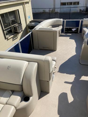 Slide: The Image of 2021 Cypress Cay C232 Tritoon interior with beige seating and spacious layout. - 9