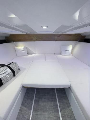 Slide: The Image of Luxurious interior of 2024 De Antonio Yachts D36 OPEN with plush white seating. - 10