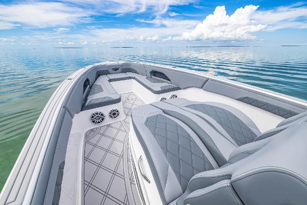 Slide: The Image of 2024 Deep Impact 369 boat interior with luxurious seating on calm water. - 27