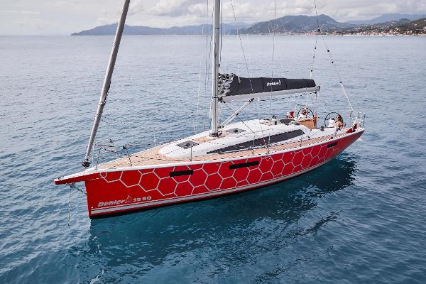 Slide: The Image of 2025 Dehler 38 SQ sailboat on calm waters with scenic coastline. - 4