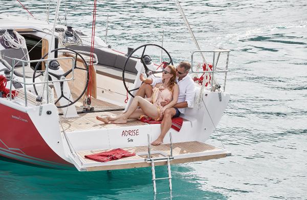 Slide: The Image of Couple relaxing on a 2025 Dehler 38 SQ sailboat in clear blue water. - 5
