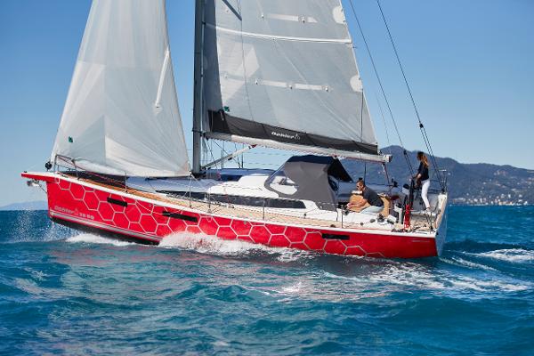 Slide: The Image of 2025 Dehler 38 SQ sailboat with red hull sailing on blue ocean. - 9