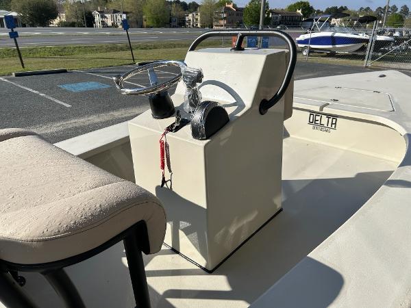 Slide: The Image of 2024 Delta Boatworks Delta 18 center console with steering wheel and cushioned seat. - 13