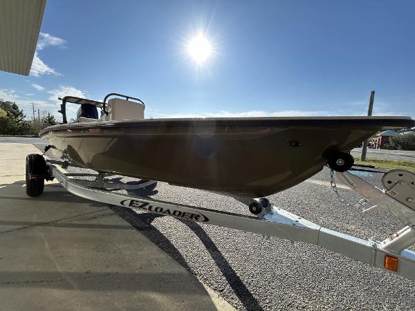 Slide: The Image of 2024 Delta Boatworks Delta 18 on EZ Loader trailer under bright sun. - 16