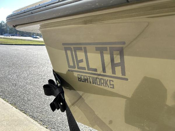 Slide: The Image of 2024 Delta Boatworks Delta 18 boat side view with logo. - 18