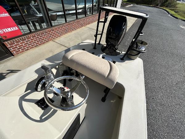 Slide: The Image of 2024 Delta Boatworks Delta 18 boat interior with steering wheel and cushioned seat. - 22