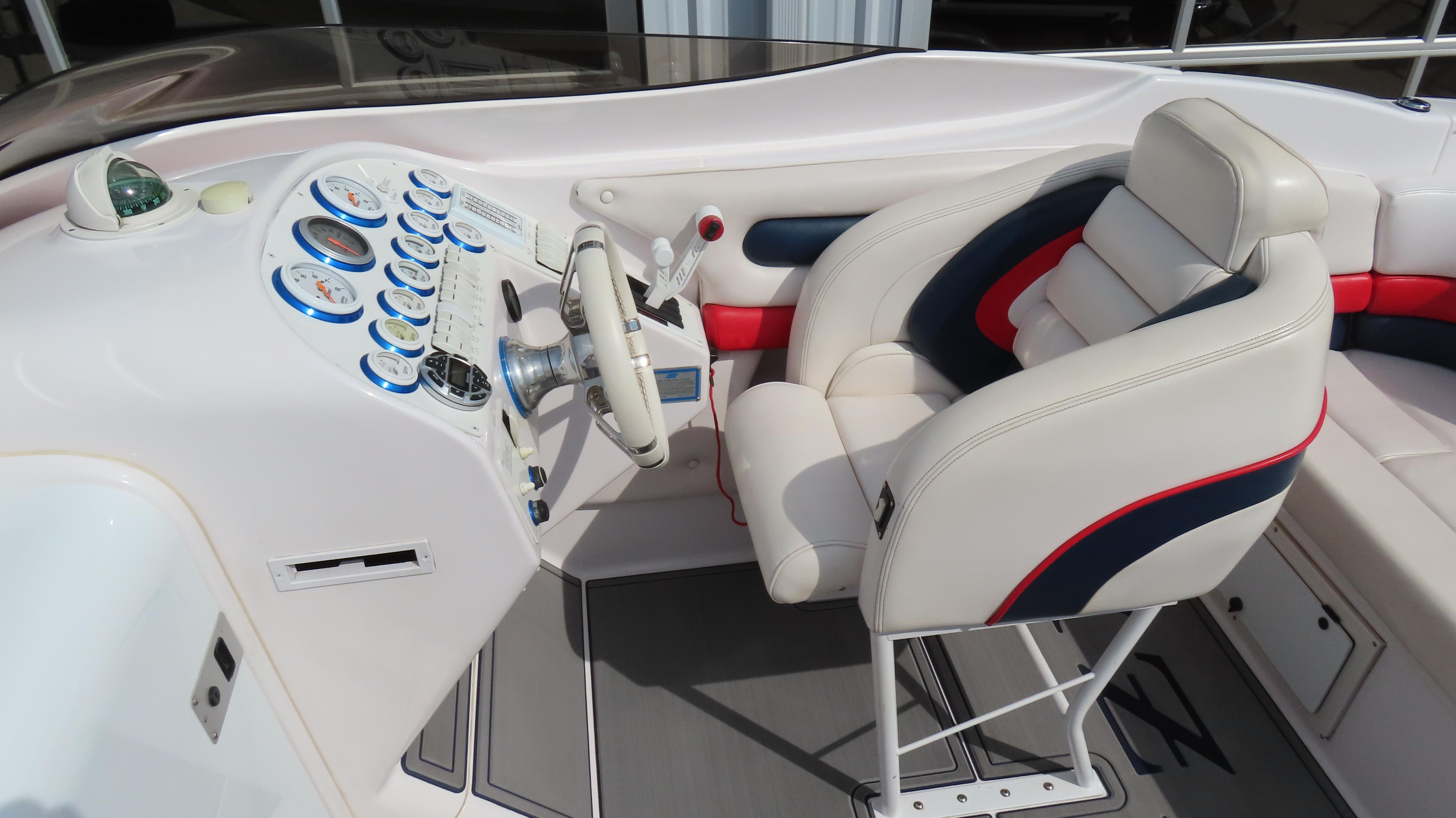 Slide: The Image of Interior of a 2000 Donzi 28ZX boat, featuring a sleek dashboard and comfortable seating. - 17