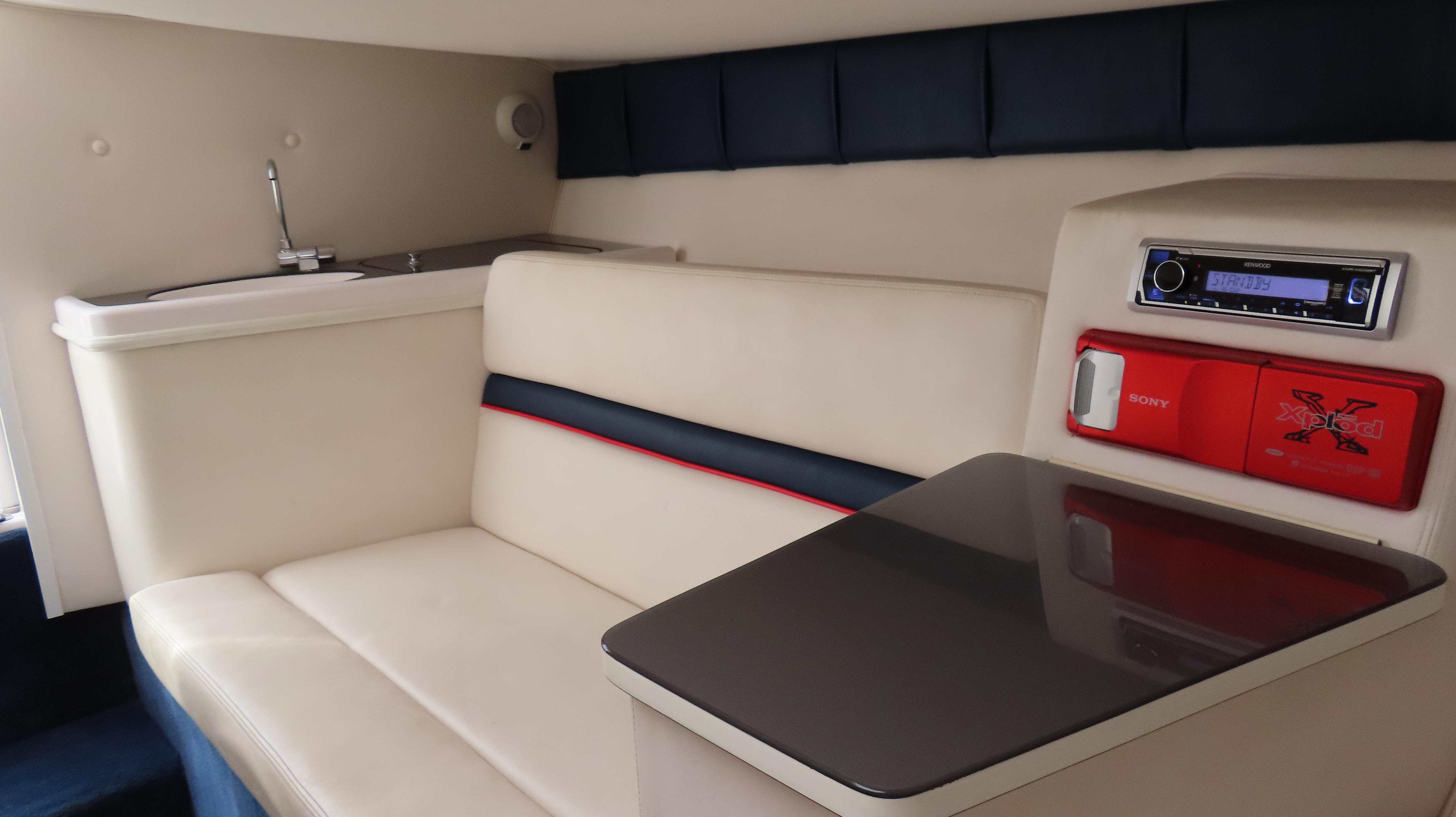 Slide: The Image of Interior of 2000 Donzi 28ZX boat with seating, table, and audio system. - 23