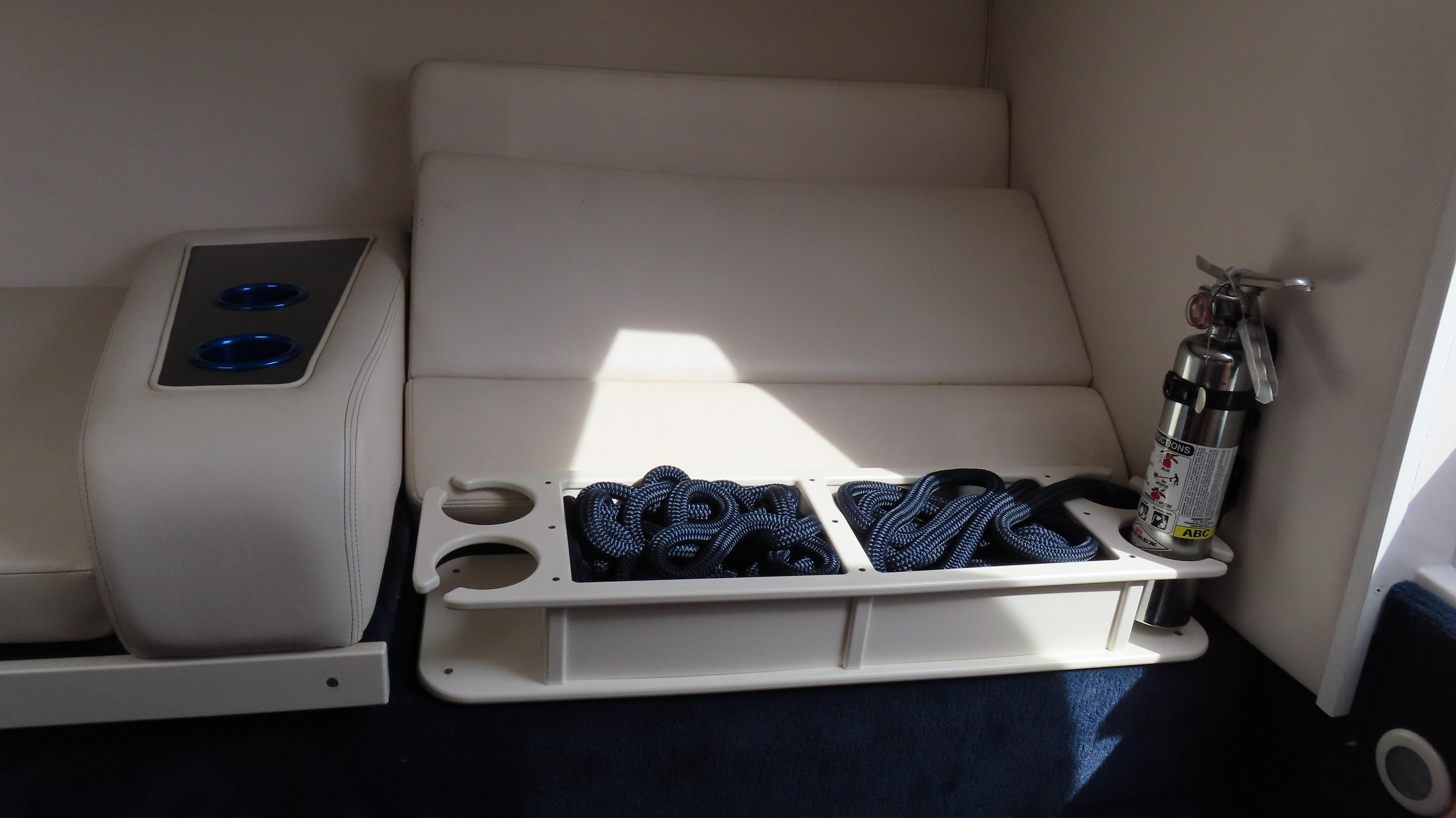 Slide: The Image of Interior of 2000 Donzi 28ZX boat with seating, cup holders, rope, and fire extinguisher. - 24