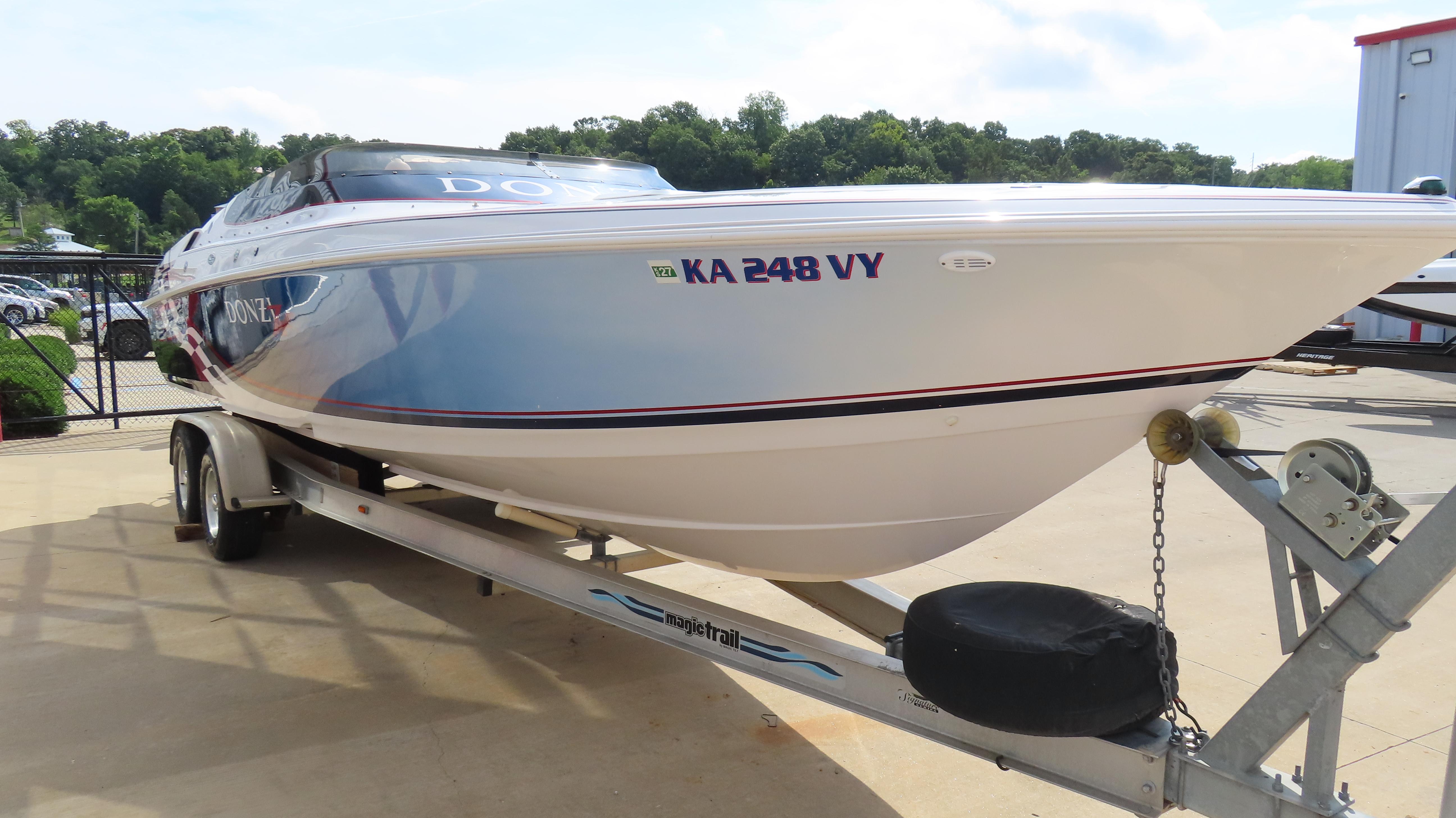 Slide: The Image of 2000 Donzi 28ZX boat on trailer, parked outdoors, with registration number KA 248 VY. - 4