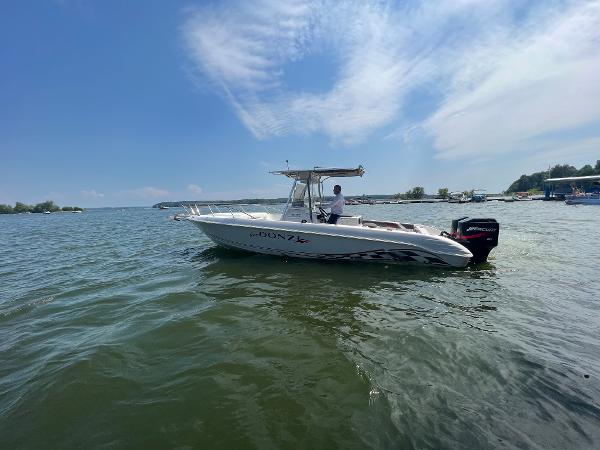 Slide: The Image of 1999 Donzi 30 ZF boat on a calm lake under a clear sky. - 17