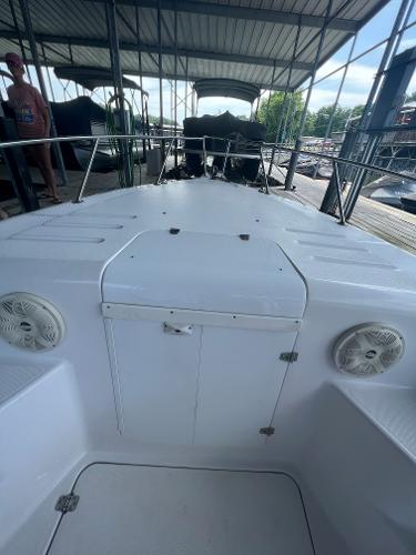 Slide: The Image of 1999 Donzi 30 ZF boat docked under a covered marina. - 32