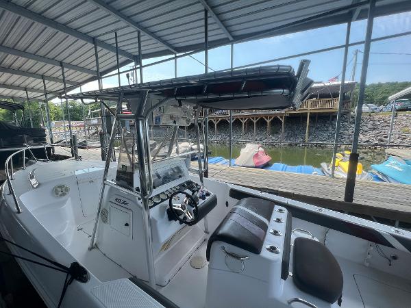 Slide: The Image of 1999 Donzi 30 ZF boat docked under a covered marina. - 39