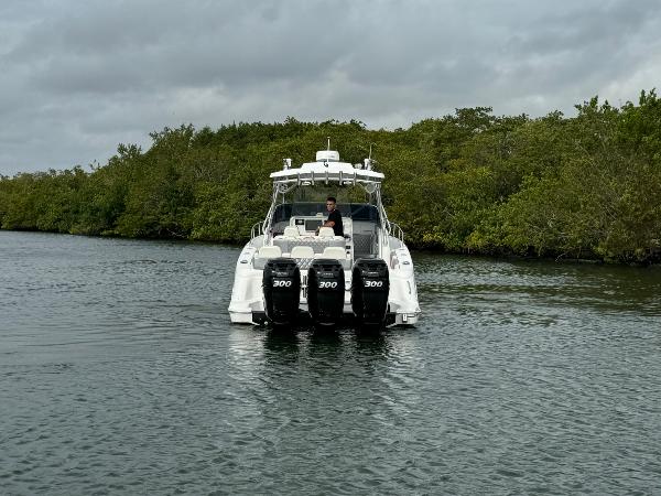 Slide: The Image of 2008 Donzi 38 ZSF boat with four 300 horsepower engines on a calm waterway. - 5