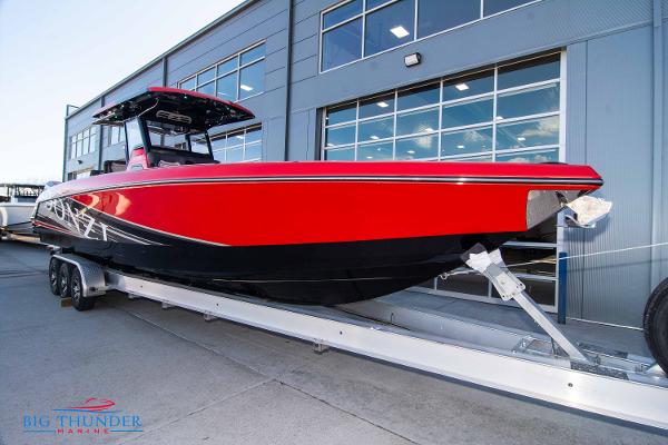 Slide: The Image of 2024 Donzi 39 VRZ boat in red and black on a trailer at Big Thunder Marine. - 18