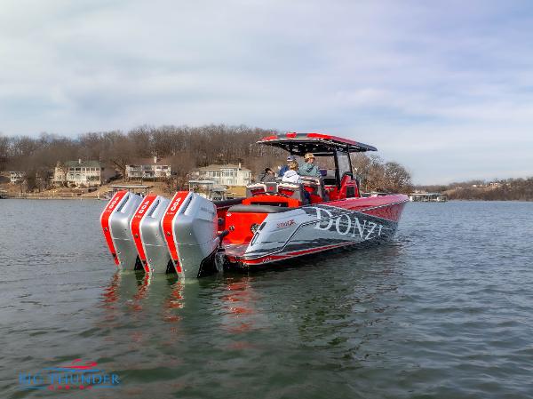 Slide: The Image of 2024 Donzi 39 VRZ boat with triple outboard engines on a lake. - 2