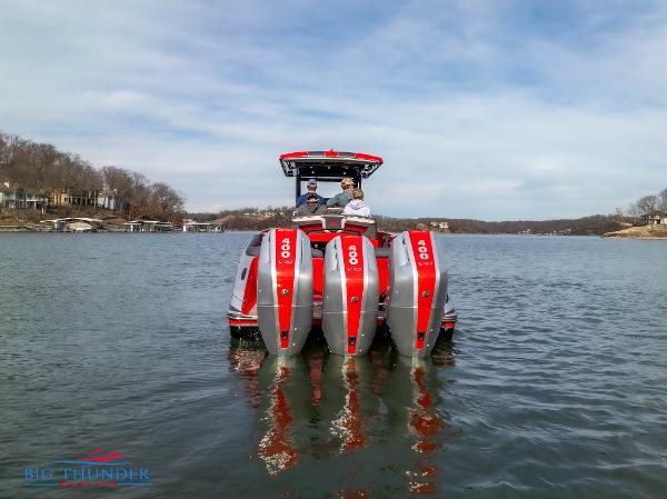 Slide: The Image of 2024 Donzi 39 VRZ boat with triple outboard engines on a lake. - 3