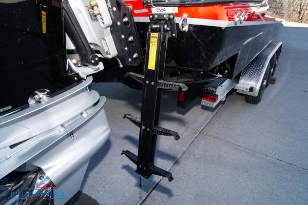 Slide: The Image of 2024 Donzi 39 VRZ boat on trailer, rear view showing outboard motor and ladder. - 34