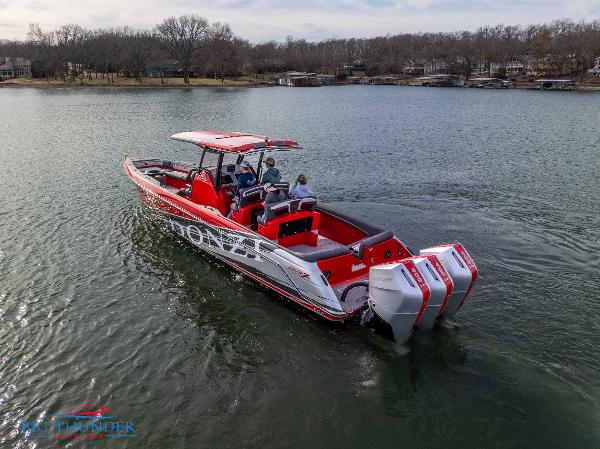 Slide: The Image of 2024 Donzi 39 VRZ boat cruising on a lake with triple outboard engines. - 8