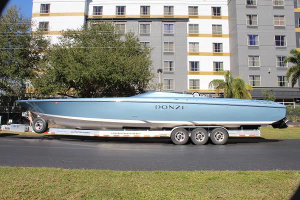 Slide: The Image of 2006 Donzi 43 ZR powerboat on a trailer in front of a building. - 1