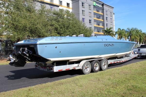 Slide: The Image of 2006 Donzi 43 ZR powerboat on a trailer, parked near a hotel. - 13