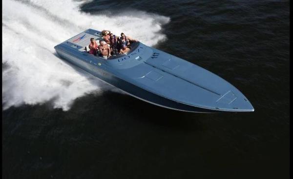 Slide: The Image of 2006 Donzi 43 ZR speedboat cruising on water with passengers. - 2